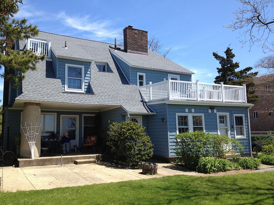 Back of house w/ separate entrance to 2nd floor (middle door, behind bush)