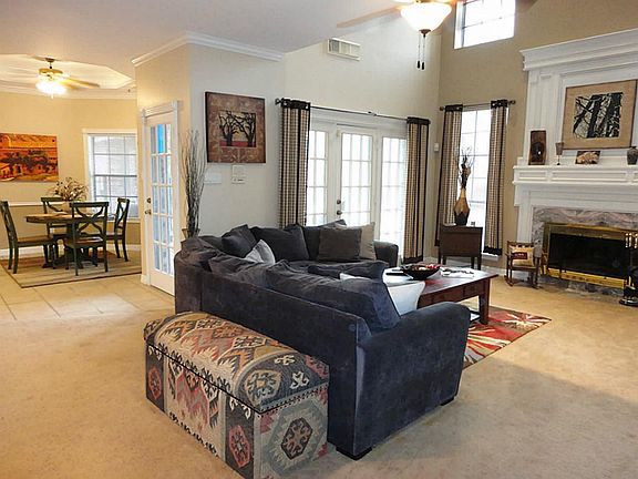 Panoramic view of living area...french door access to backyard, majestic fireplace, 2 storey windows provide a fabulous view of pool and lushly landscaped backyard.