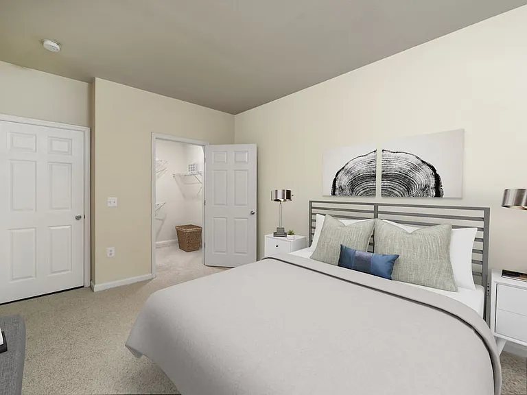 Renovated II bedroom with carpeted flooring and walk-in closet