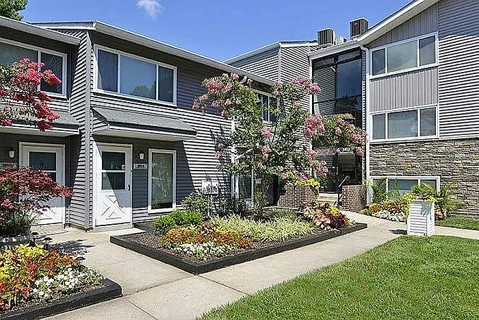 Experience modern living with this beautifully landscaped apartment exterior.