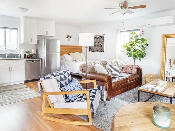 Open-concept studio layout with full kitchen, sleeping area, and living space
