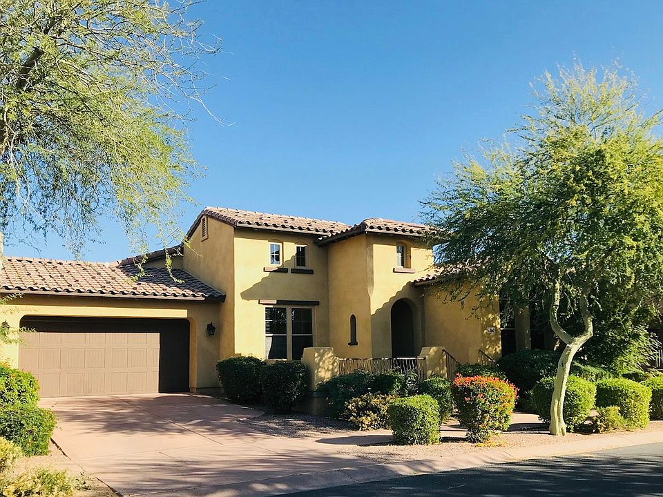Front image of this single level home Patio with a view of the adjacent neighborhood park. Looks like a 2 car garage but it is a 4 car tandem garage (2X2)