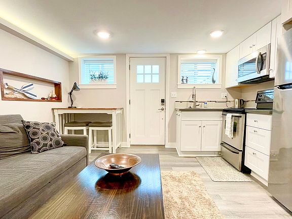 Livingroom, entrance door, and kitchen areas.