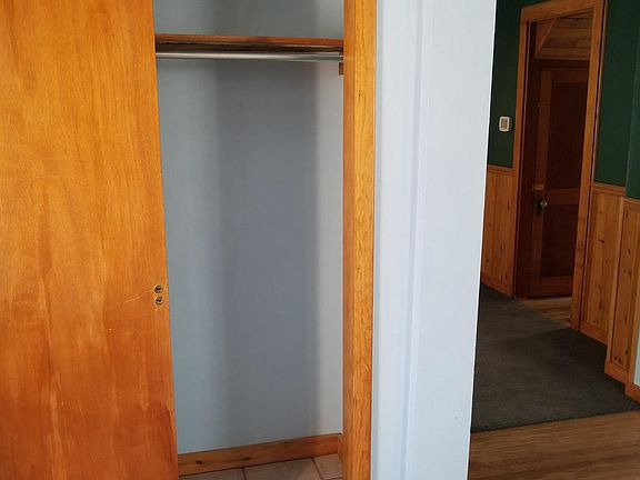 Front door coat closet looking into living room