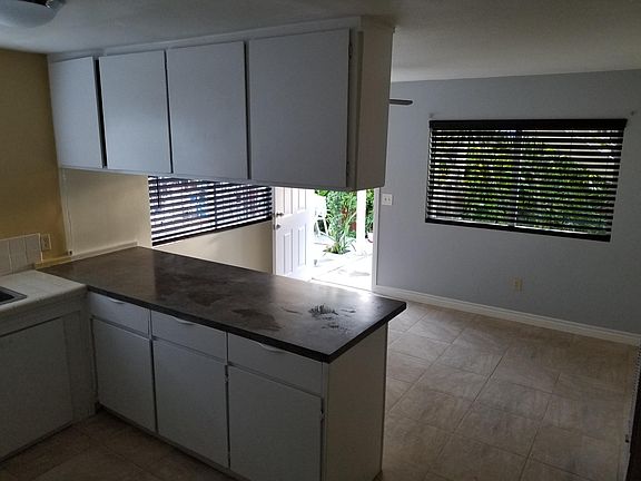 Connected kitchen to open living room space. Cabinets and walls newly painted.
