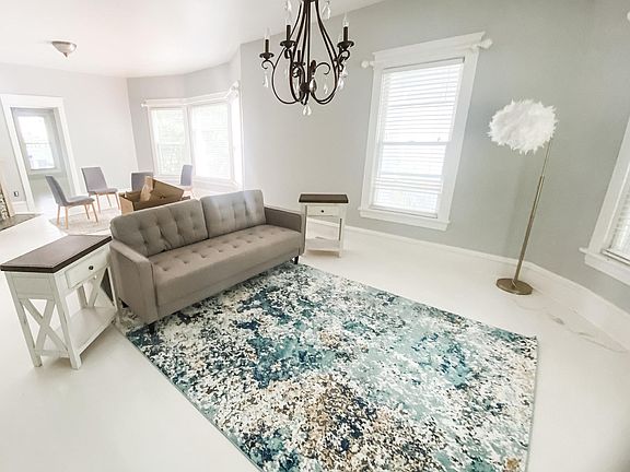 Large dining/living room with a bay window.