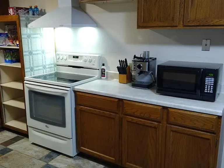 Pantry, Electric stove with vented hood, Lots of storage, Knives, Coffee maker, Microwave, cookware, utensils, etc...more