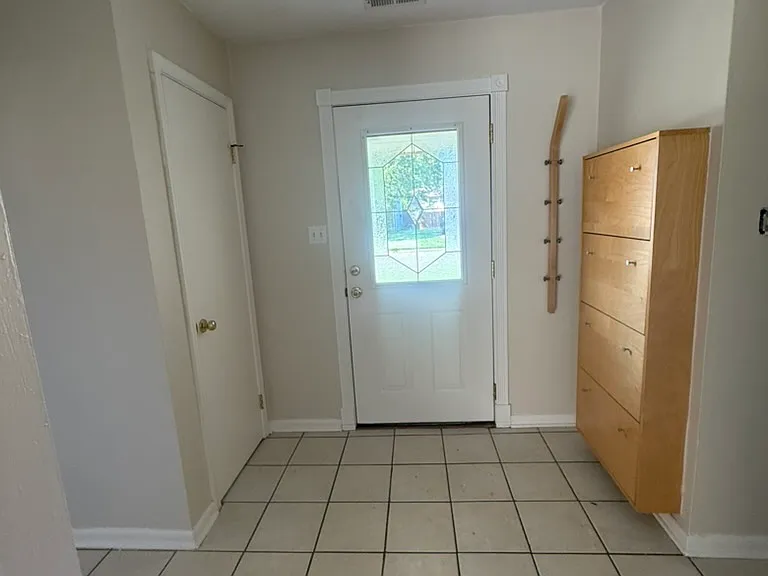 Front door with installed coat and shoe rack.
