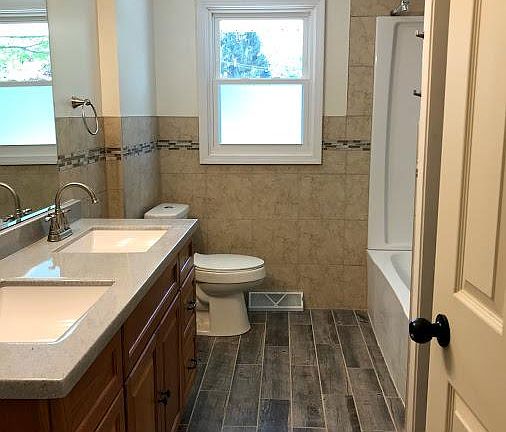 Double sink vanity, remodeled bath with tub/shower