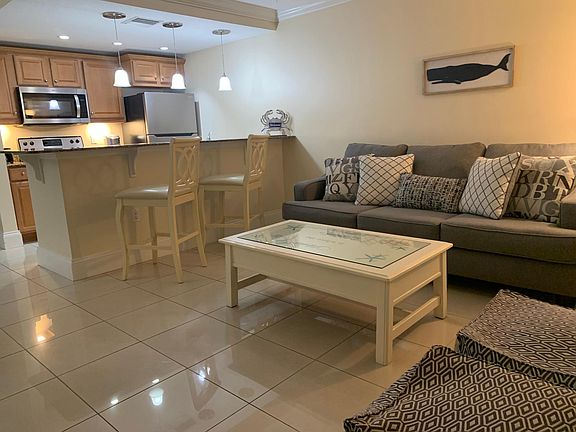 Open great room with beach themed d_cor