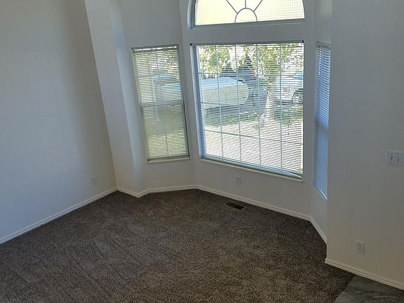 Large front living room with beautiful wood railing and vaul