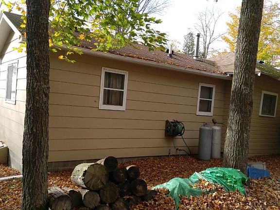 Front of cabin and east side with lake behind.