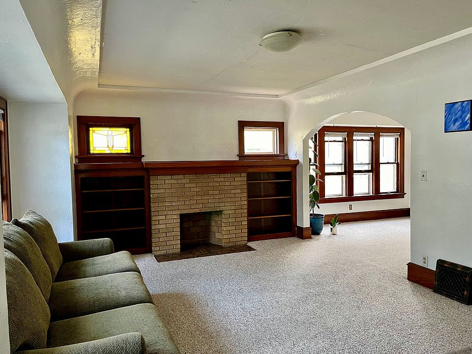 Sunny living room with built-in shelving for added convenience and storage.