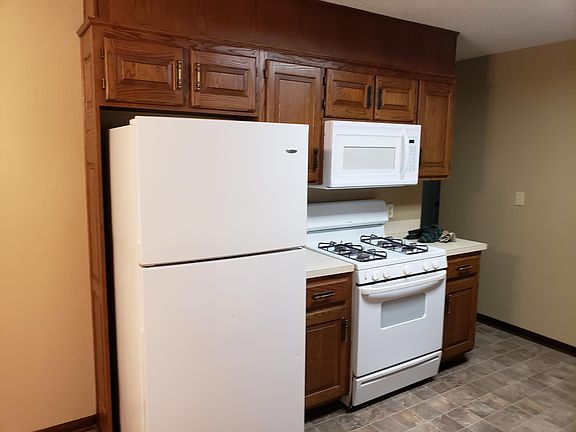 Large eat in kitchen with nice hard wood cabinets, built in microwave, gas range, refrigerator, dishwasher, garbage disposer and more.