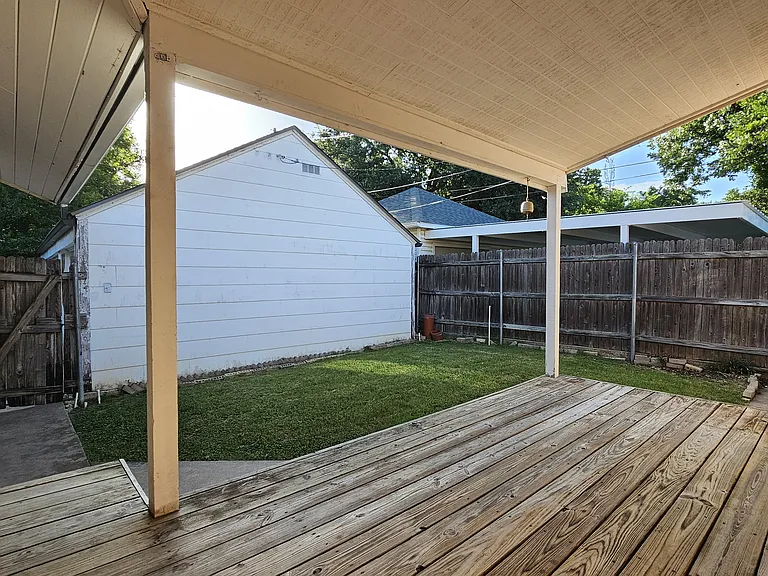Private fenced porch looking over the backyard, ready for pets, entertaining, or relaxing.