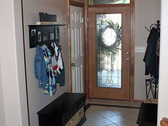 Tiled entry, leaded glass door.