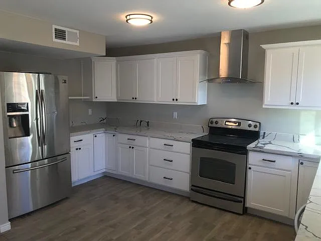 Expanded kitchen features new Cabinets, stainless appliances and hood, quartz counters.