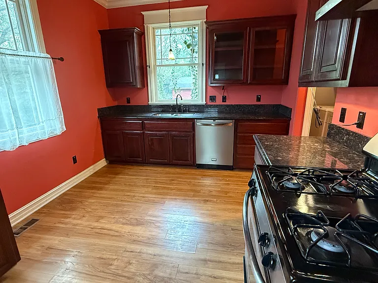 Large kitchen with sunny windows and exit door to back deck