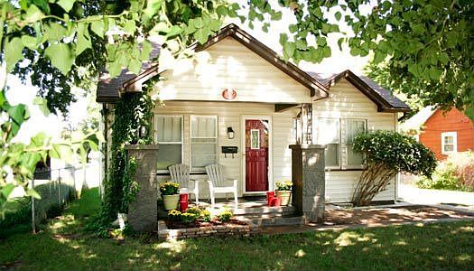 covered front porch lined with charming English Ivy