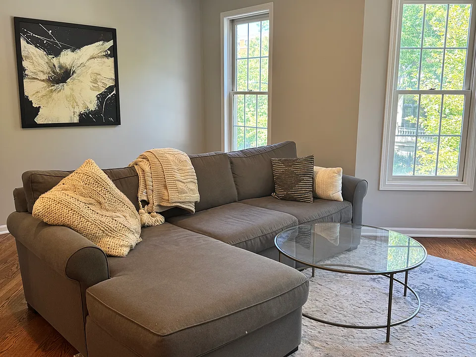 Spacious living room with natural light and room for sectional seating.