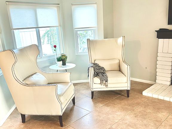 Step into your beautiful home. Inviting living room with a view of the front courtyard. Features include a fireplace, bay windows, neutral tile and plenty of room for entertaining.