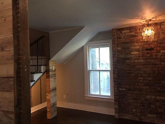 small room from front door, lighted and open under the stairs