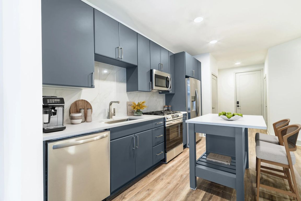 Contemporary kitchens at Modera Westside Trail offer a stylish island and sleek finishes, creating an inviting space for everyday living.