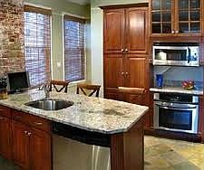 kitchen w/ grantie and stainless appliances.   Wet bar area also (not shown)