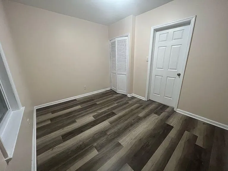 (Bedroom A 1/2) Built in closet offering shelving space and a rod for hanging clothes. Door swings into the living room leaving more space to utilize inside.