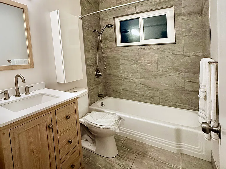 Completely Remodeled Unit : Hall Bath with Premium Imported Italian Tiles.