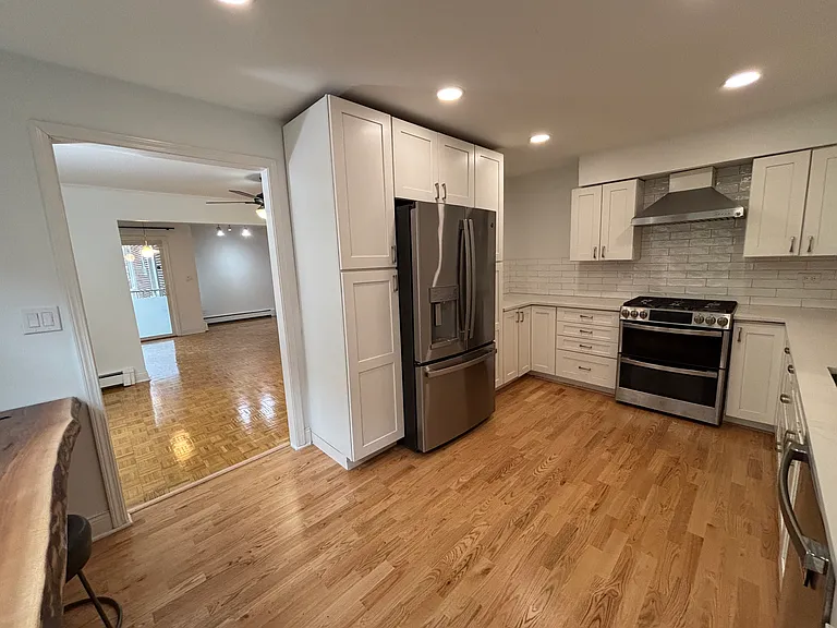 kitchen looking into dining room then living room and balcony door