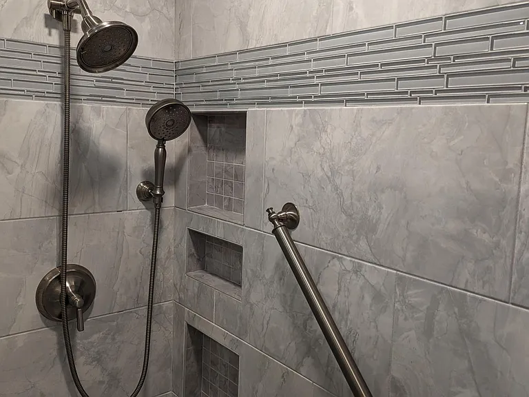 master bath large shower heads, grab bars, custom tile, niches