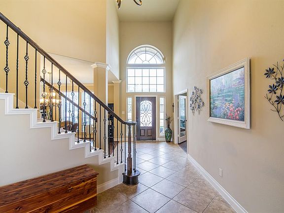 Your entry is framed by a library and a formal dining room, both with hardwood floors.