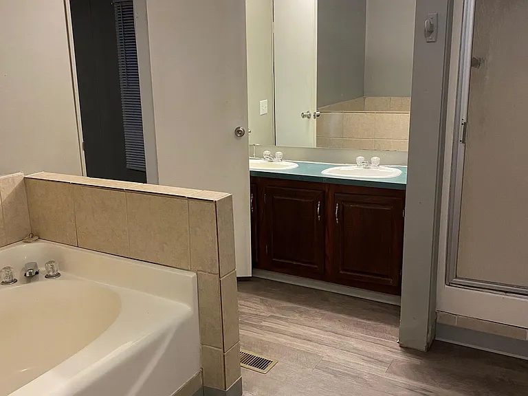 Primary bathroom with large bathtub and separate shower