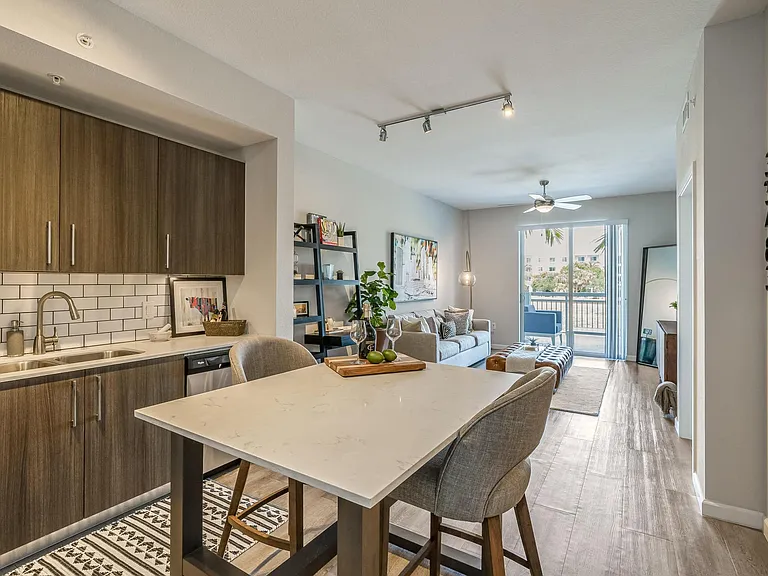 Island with Seating and Full Kitchen Facing Sofa and Sliding Doors