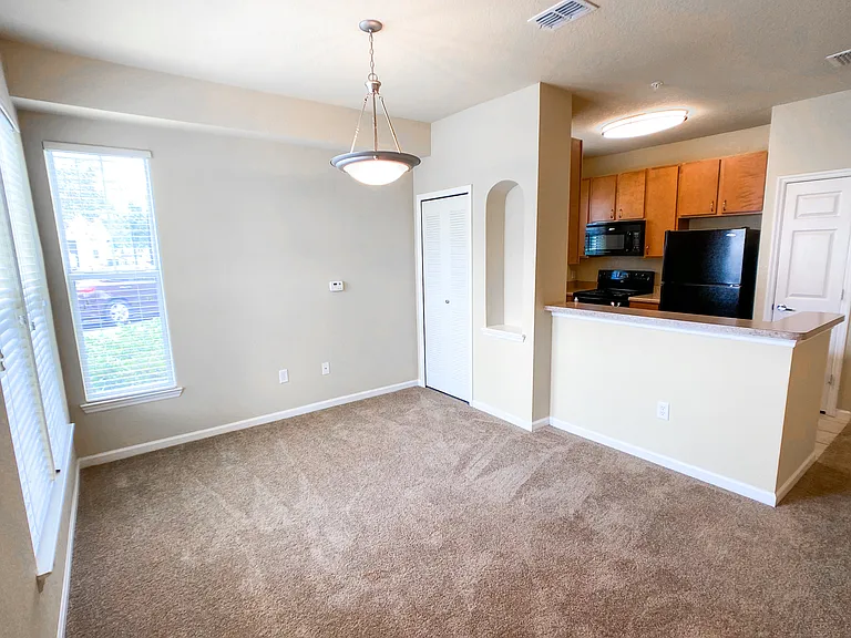Open Concept Design with Lush Carpets in Living and Dining Room Open Concept Design with Lush Carpets in Living and Dining Room