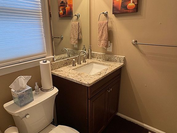 The upstairs bathroom includes a built-in medicine cabinet, providing added storage and functionality in a clean, well-designed space.