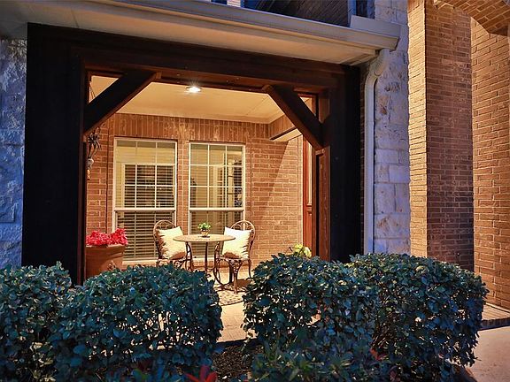 CHARMING FRONT PORCH WITH WOOD POSTS - Imagine having a morning coffee on this quaint front porch. Cedar Wood framing wraps the porch to give this home a hill country feeling! The Garage Doors and Second Story Board N Batten shutters have been recent