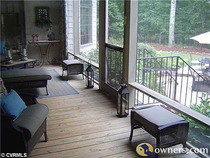 Screened in porch overlooks pool area