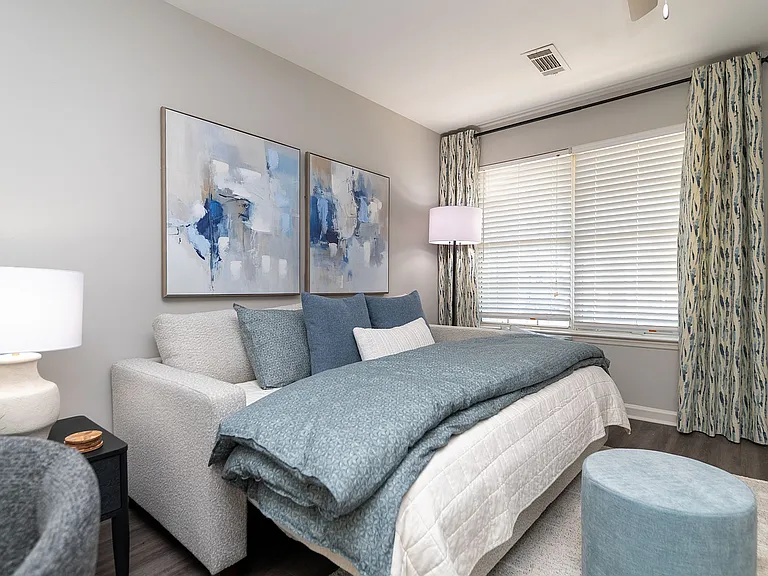 Spacious open living & sleeping area with hardwood-style flooring