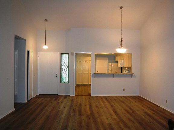 From living room towards front door and kitchen