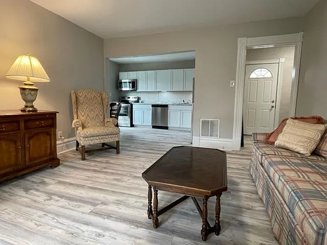 The spacious living room flows seamlessly into a fully remodeled open-concept kitchen, creating a bright and inviting space that's perfect for both everyday living and entertaining.