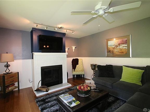 ceiling fan in family room which opens into screened in porch