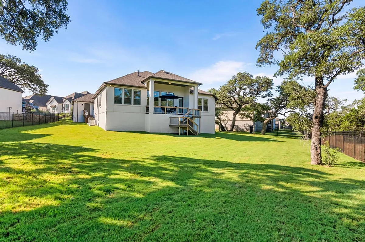Enormous semi-private back yard that backs to trees. One of the largest in Esperanza. Direct access to the yard from the house, just off the expanded covered patio or from the 4-car garage. - 114 Sonrisa