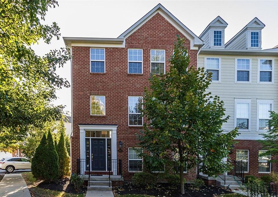 End unit with large green space and trees outside front door.