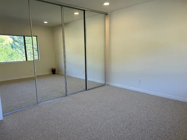 Mirrored doors conceal another custom closet.