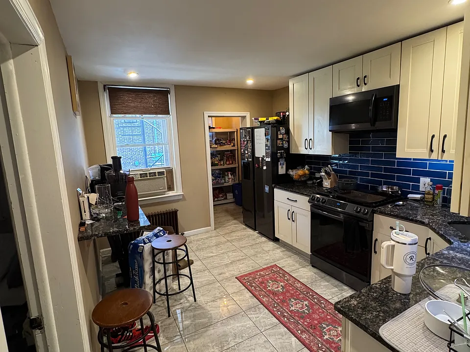 Kitchen with breakfast bar fitted with granite counter top.
