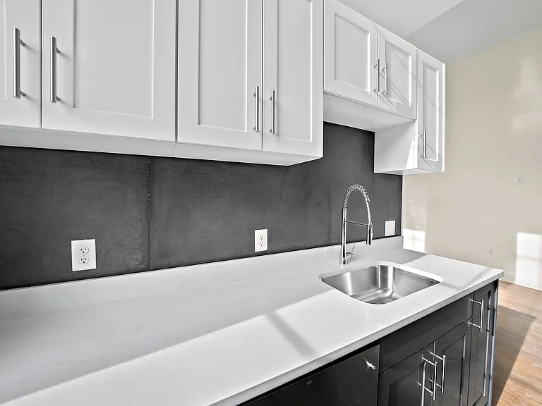 Original blackboards from Holy Family High School used as backsplash in each kitchen.