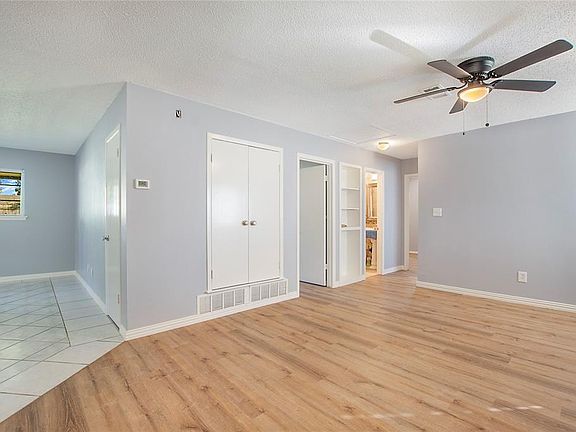 Spare room with ceiling fan, a textured ceiling, and light hardwood / wood-style flooring