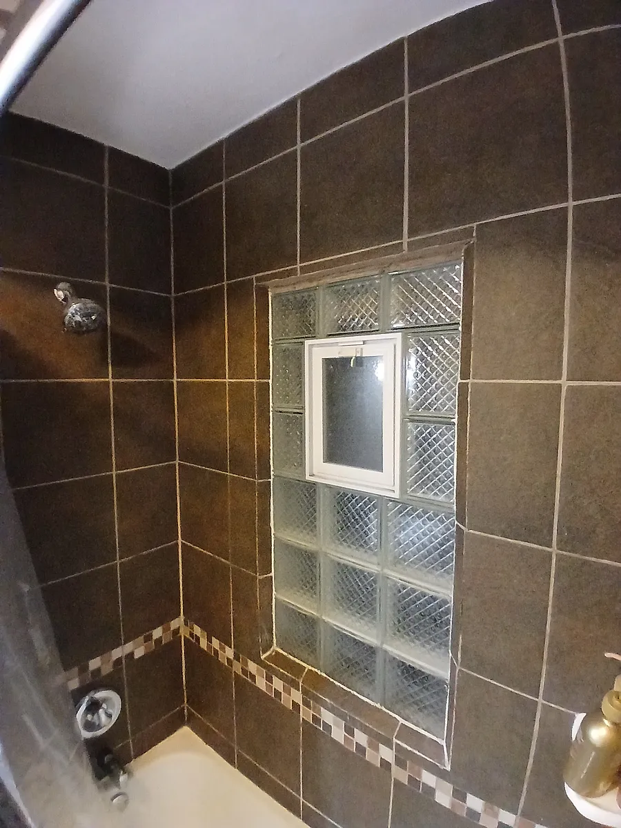 Tiled bathroom with deep tub. - 4335 Knox Ave N